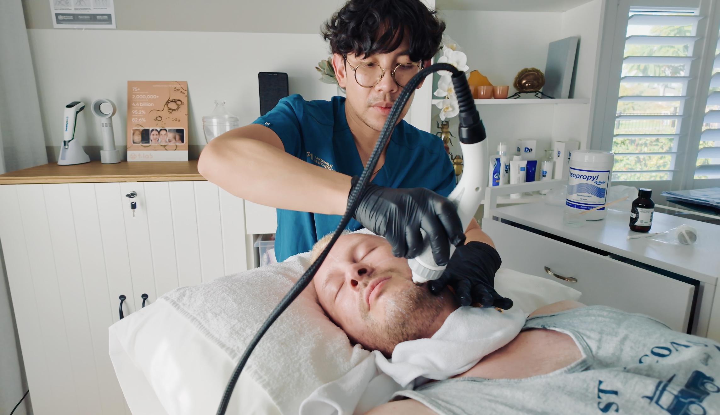 Close-up of microneedling pen device on skin