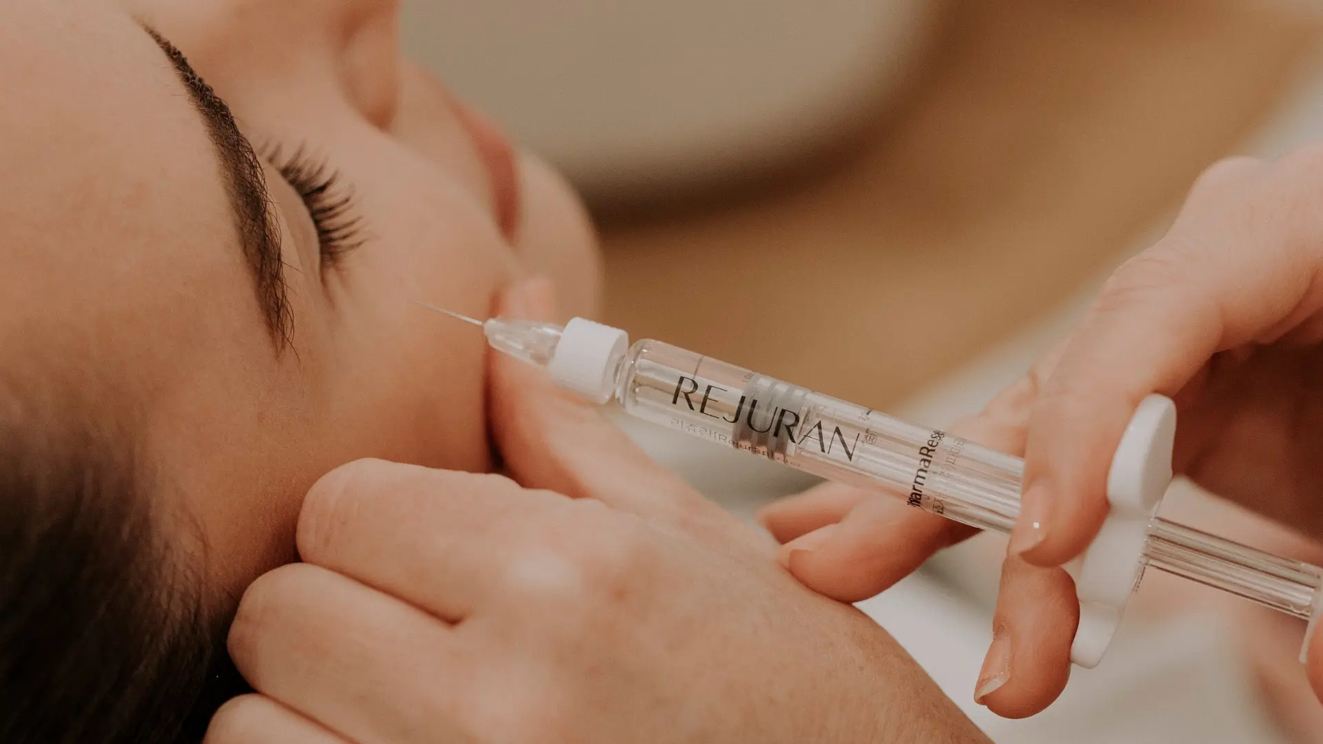 A client receiving a skin treatment at Vellia Aesthetics